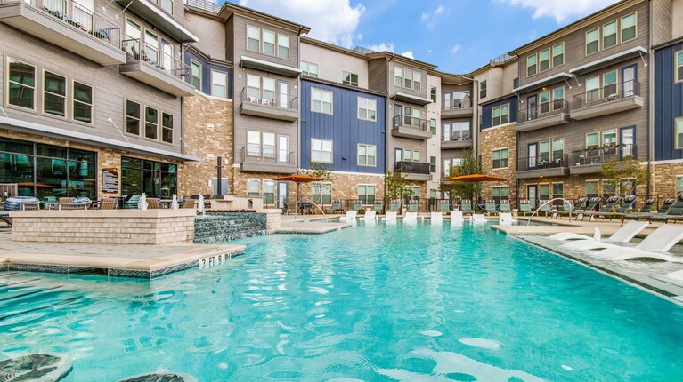 Pool with shaded swim-up bar and lounge seating