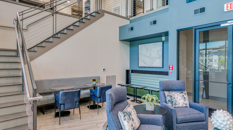 Two-story resident lounge with seating areas